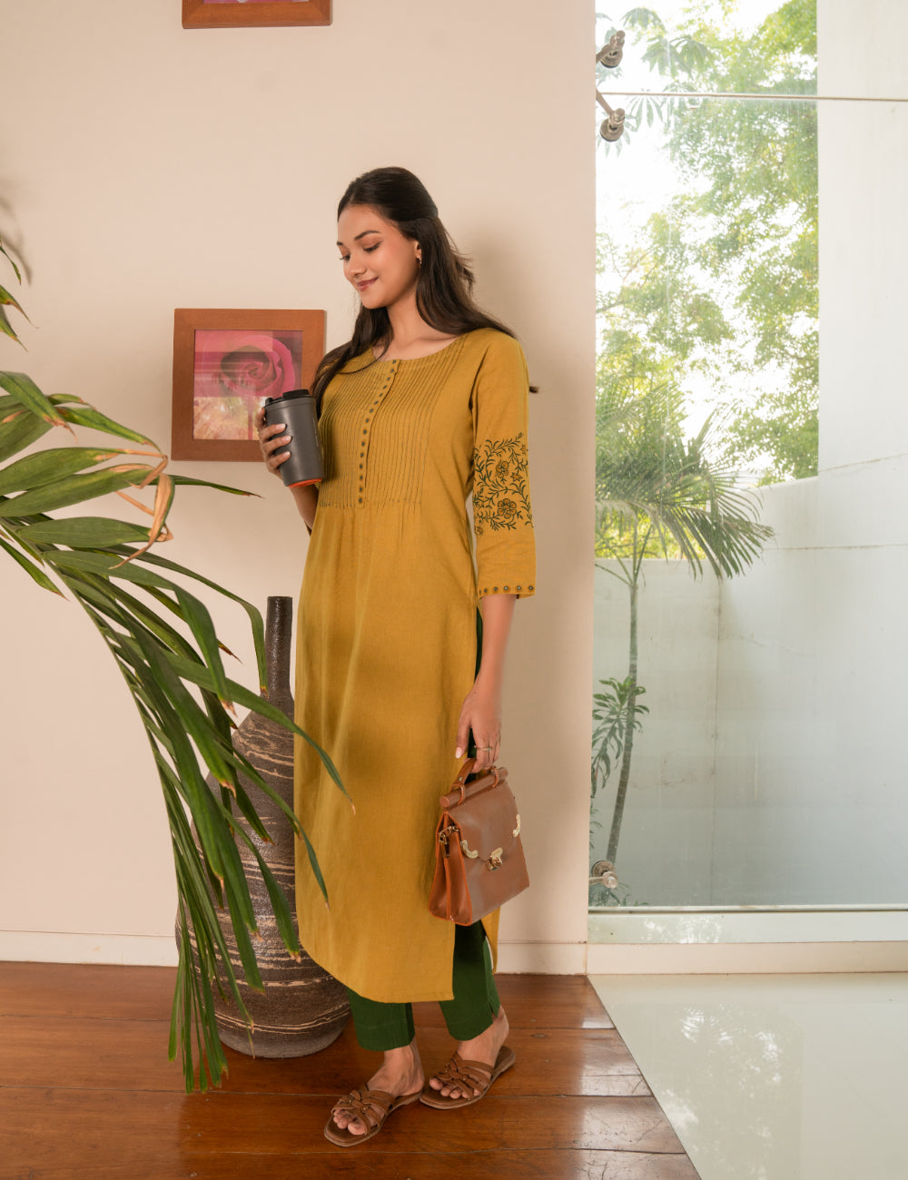 Straight fit kurta with pintucks and block printed sleeves and placket highlighted with mirrors.