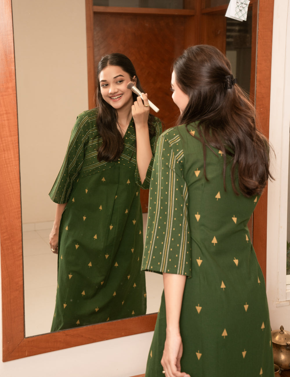 A centre pleated straight fit kurta in complimenting dobby fabric with mirror work.