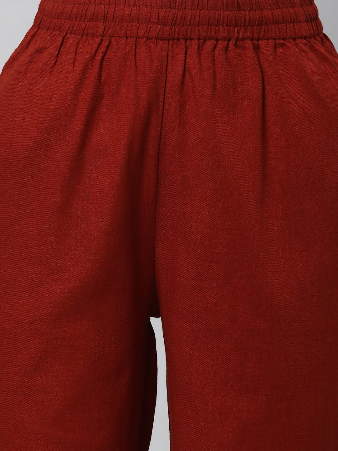 A fully elasticated rust ankle length cotton linen pant