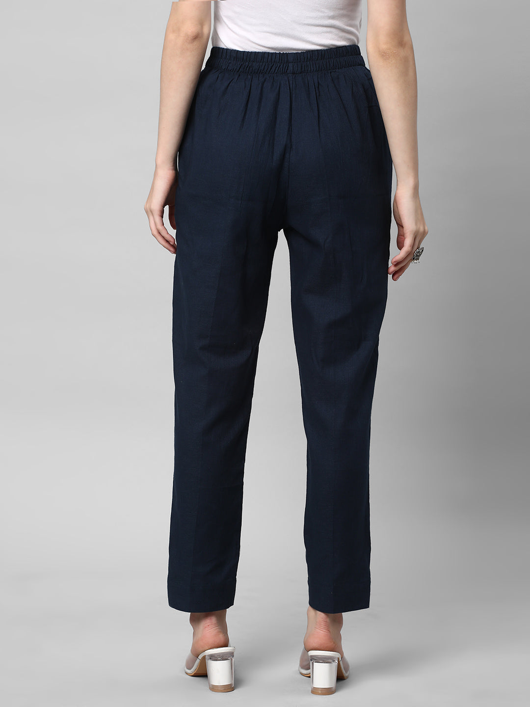 A blue ankle length cotton linen pant with plain belt in front