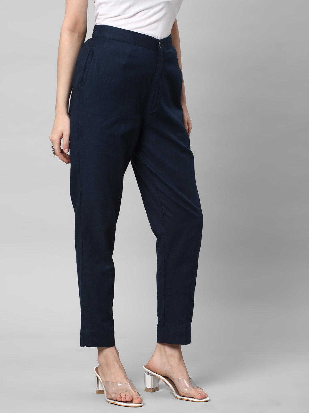 A blue ankle length cotton linen pant with plain belt in front