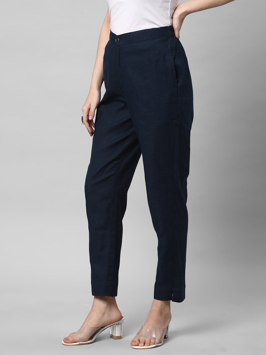 A blue ankle length cotton linen pant with plain belt in front