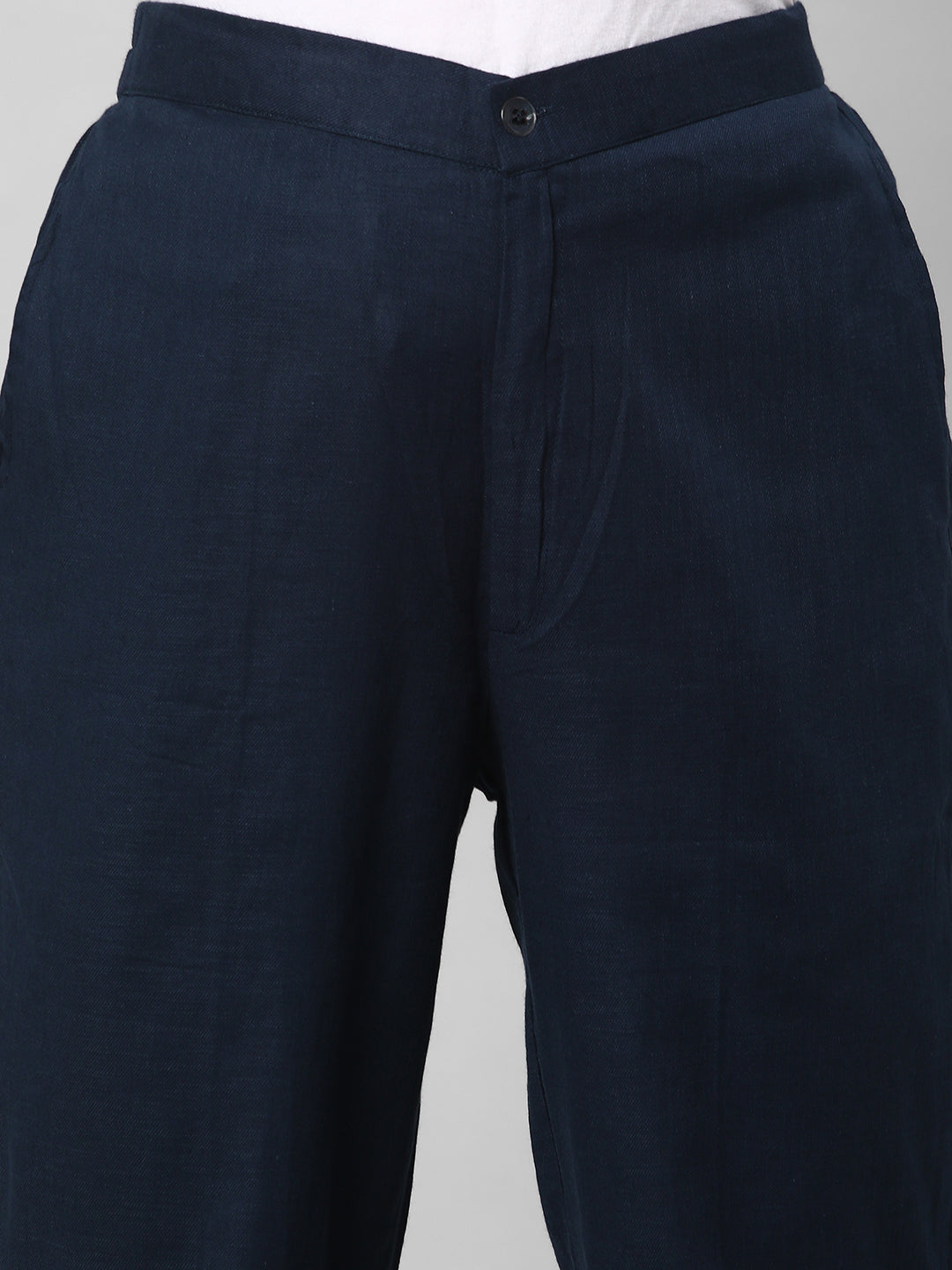 A blue ankle length cotton linen pant with plain belt in front