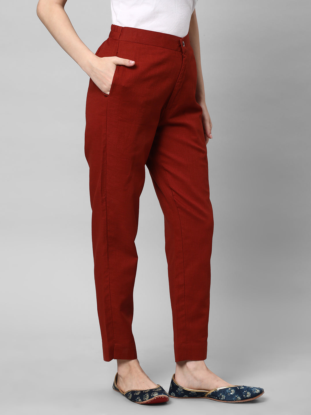 A Rust ankle length cotton linen pant with plain belt in front