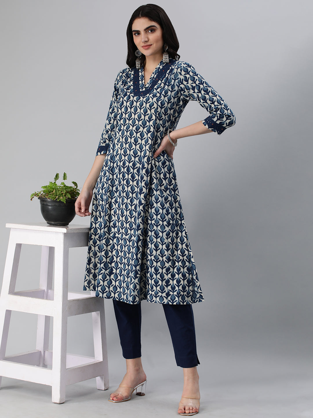 A flared bagru printed kurta with schifli detailing on V neck and cuff