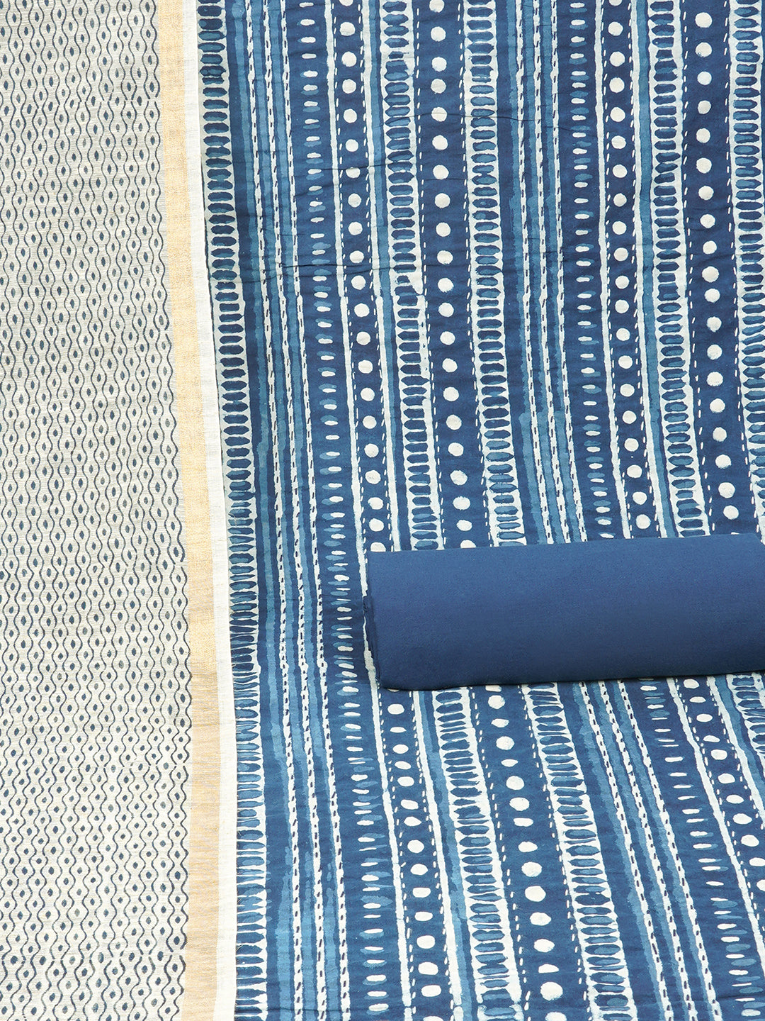 Blue unstitched suit set with traditional geometric dabu print along with printed dupatta and solid bottom