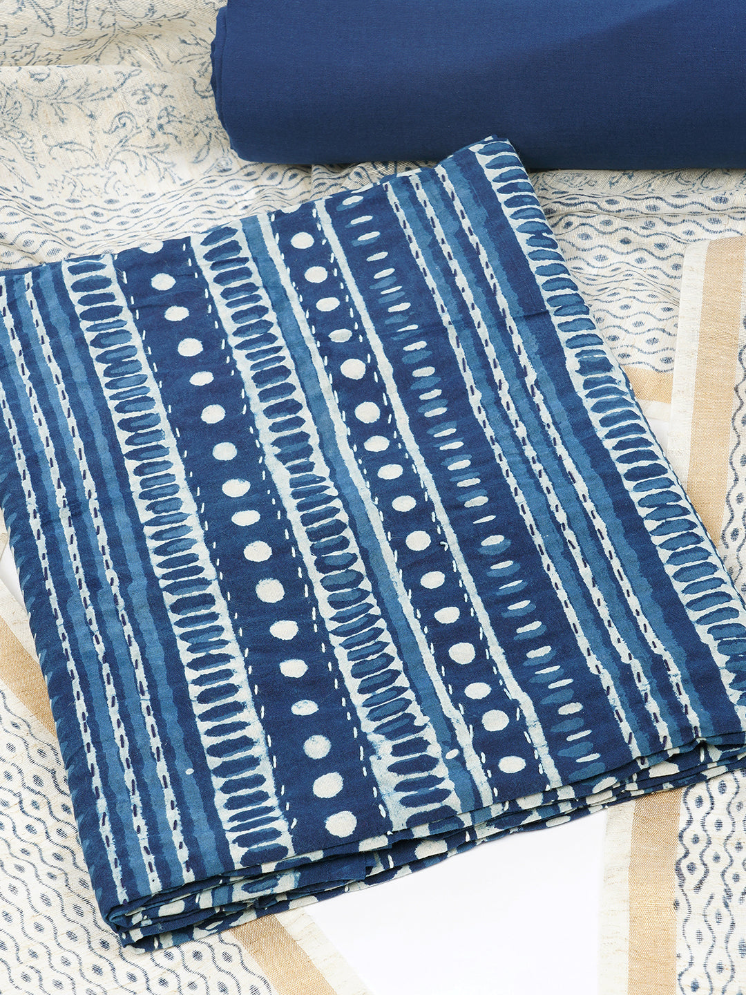 Blue unstitched suit set with traditional geometric dabu print along with printed dupatta and solid bottom