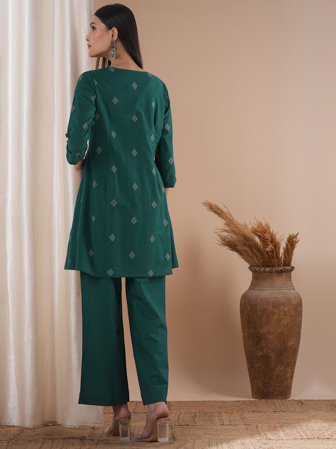 A co-Ord set with a lapel collar top with loop detailing on the sleeves paired with solid palazzos