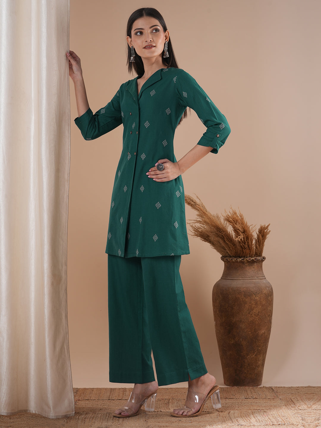 A co-Ord set with a lapel collar top with loop detailing on the sleeves paired with solid palazzos