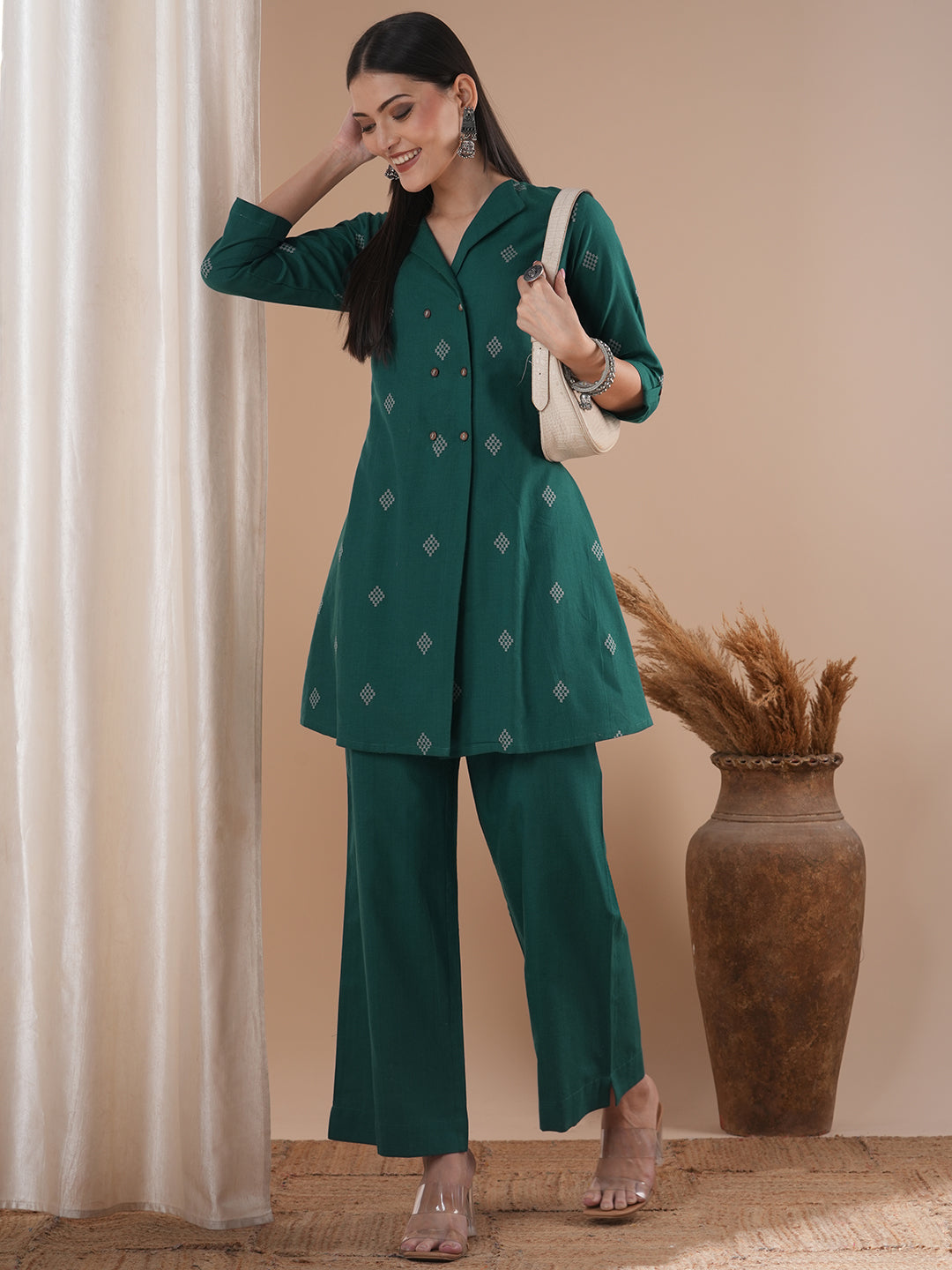 A co-Ord set with a lapel collar top with loop detailing on the sleeves paired with solid palazzos