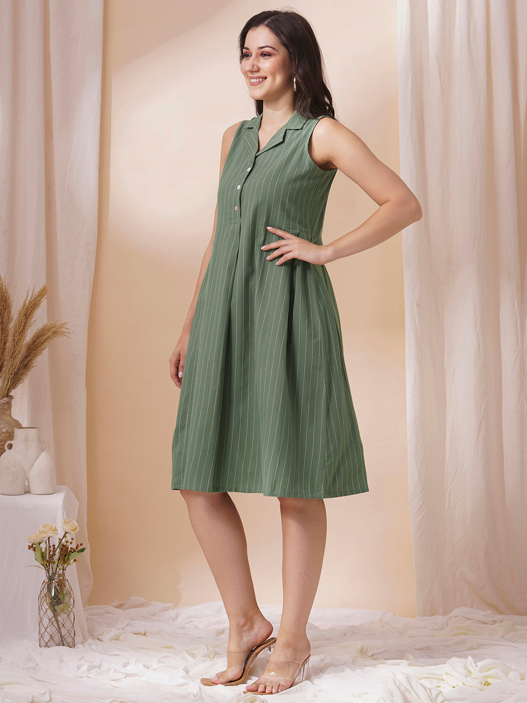 Striped sleeveless dress with notch collar and a side box pleat.