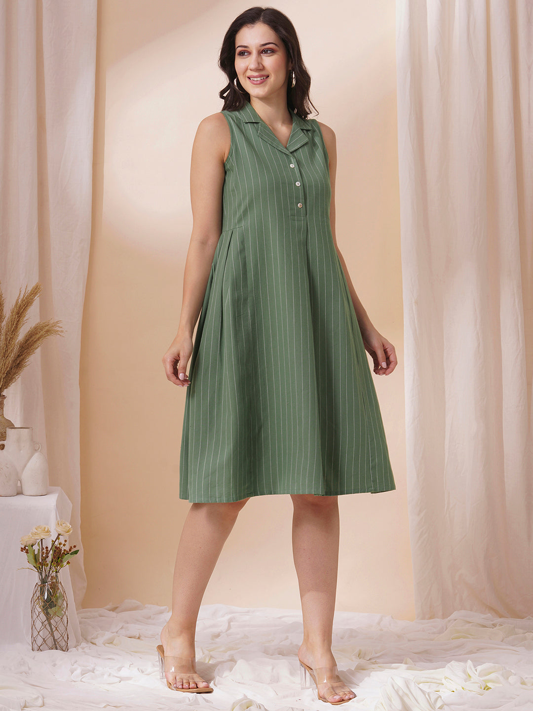 Striped sleeveless dress with notch collar and a side box pleat.