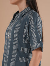 A collared printed dress with stripe manipulation panels, dual pockets and half sleeves with cuff