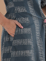 A collared printed dress with stripe manipulation panels, dual pockets and half sleeves with cuff