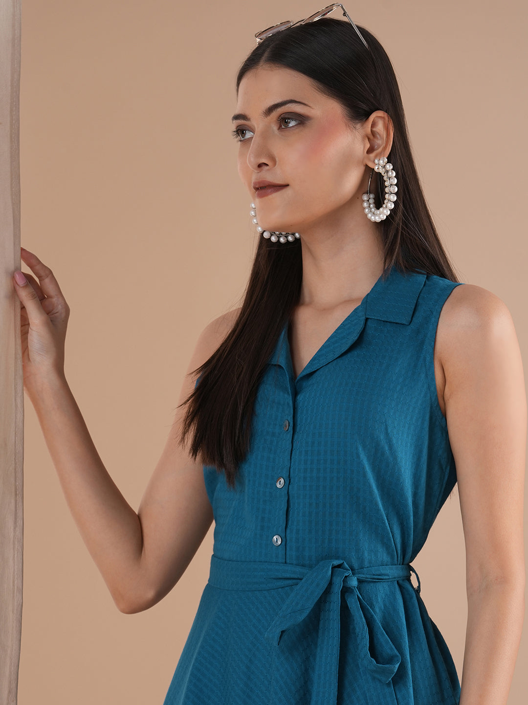 Fit and flared sleeveless dress with notch collar, centre placket with waist tie-up