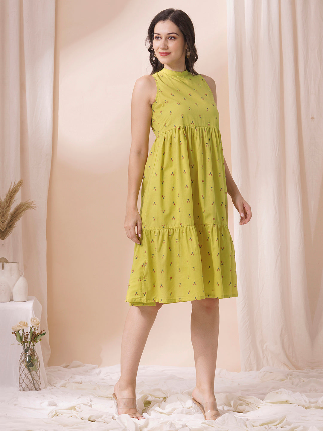 Gathered tiered sleeveless dress with back neck tie-up detailing on dobby fabric.