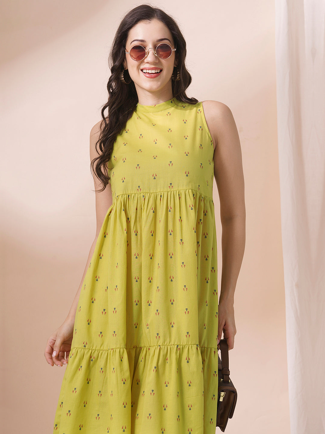 Gathered tiered sleeveless dress with back neck tie-up detailing on dobby fabric.