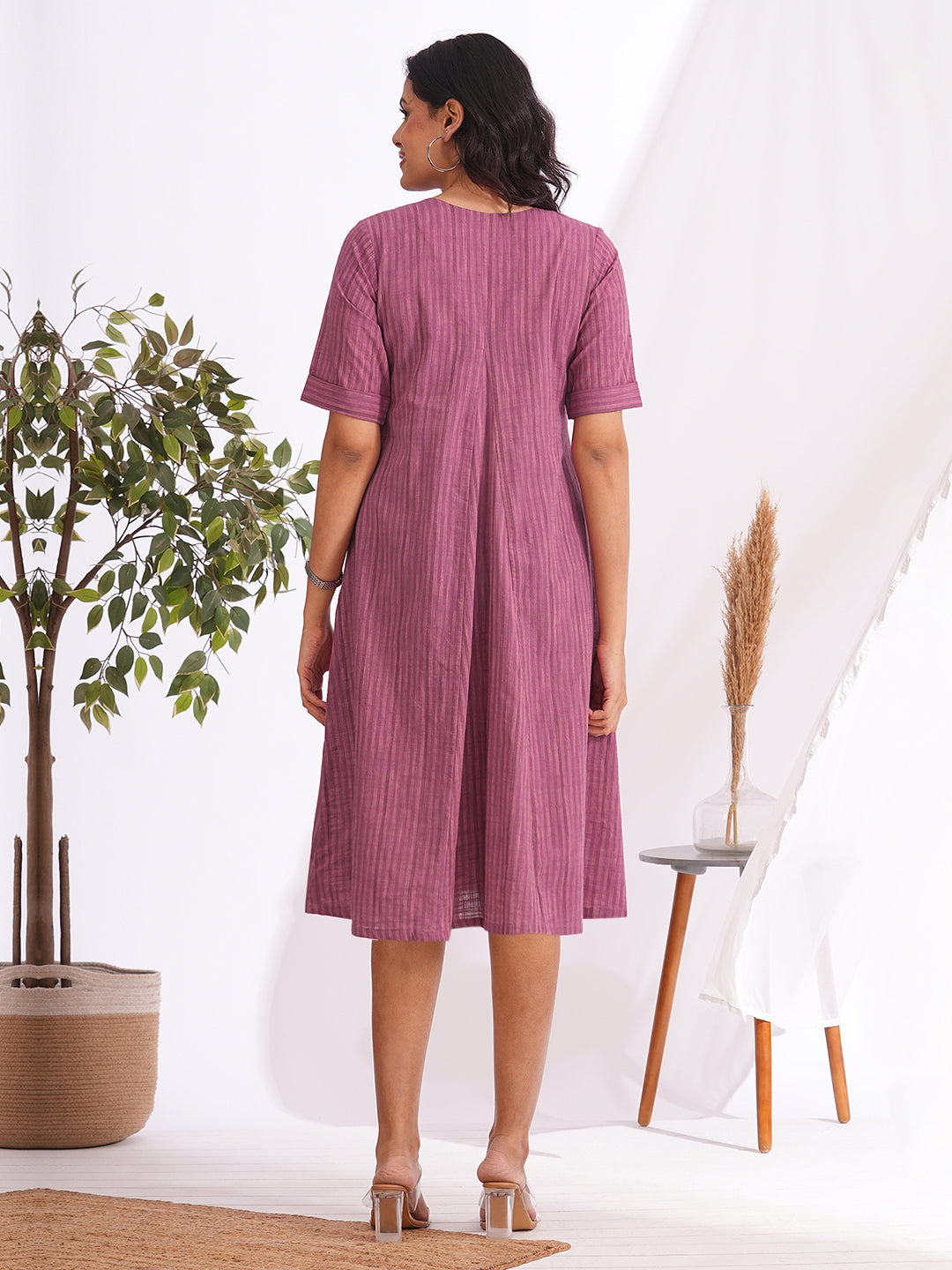 woven striped dress highlighted with block print and shaped side panels with pockets