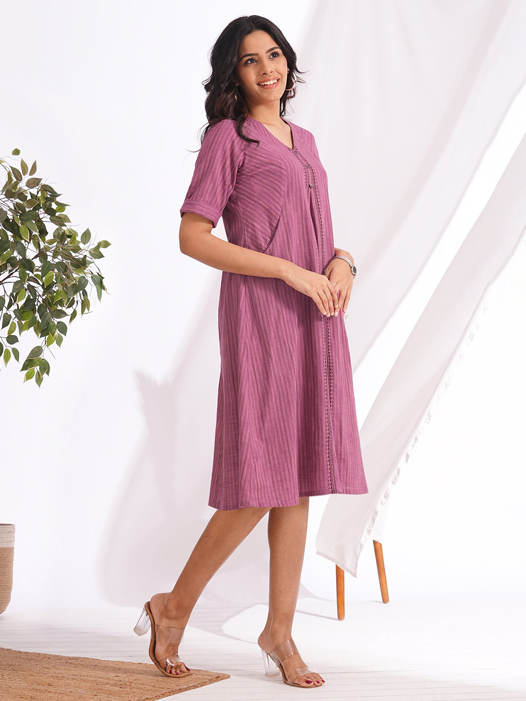 woven striped dress highlighted with block print and shaped side panels with pockets