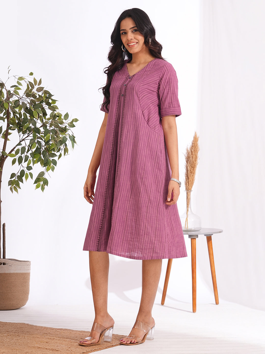 woven striped dress highlighted with block print and shaped side panels with pockets