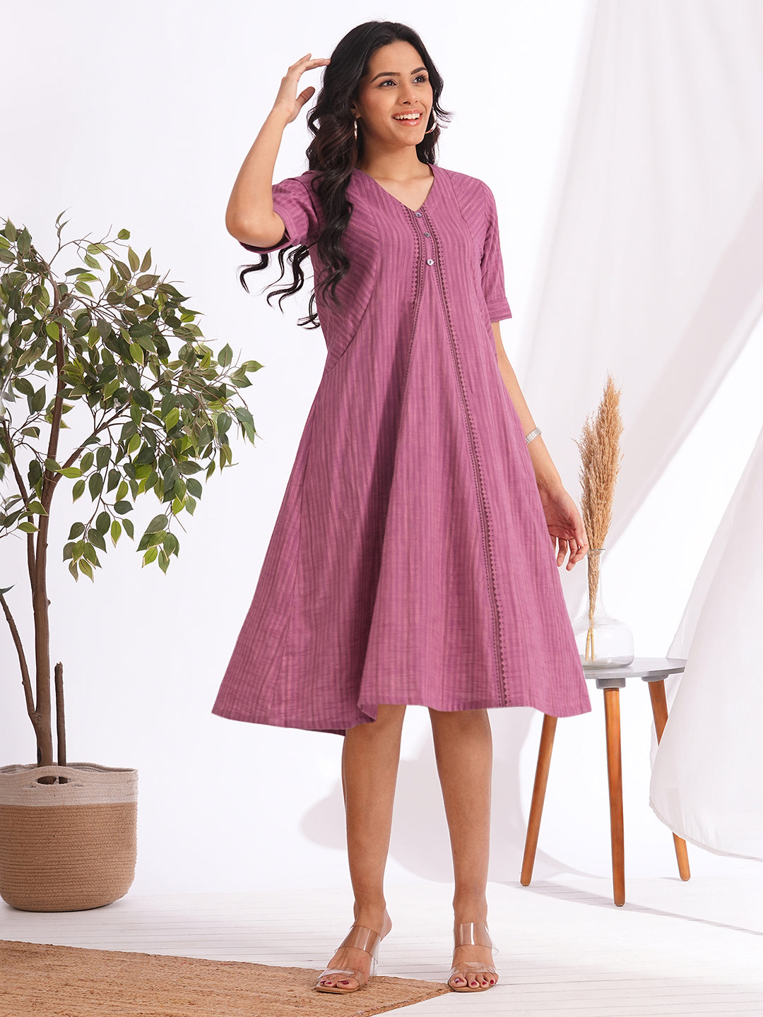 woven striped dress highlighted with block print and shaped side panels with pockets