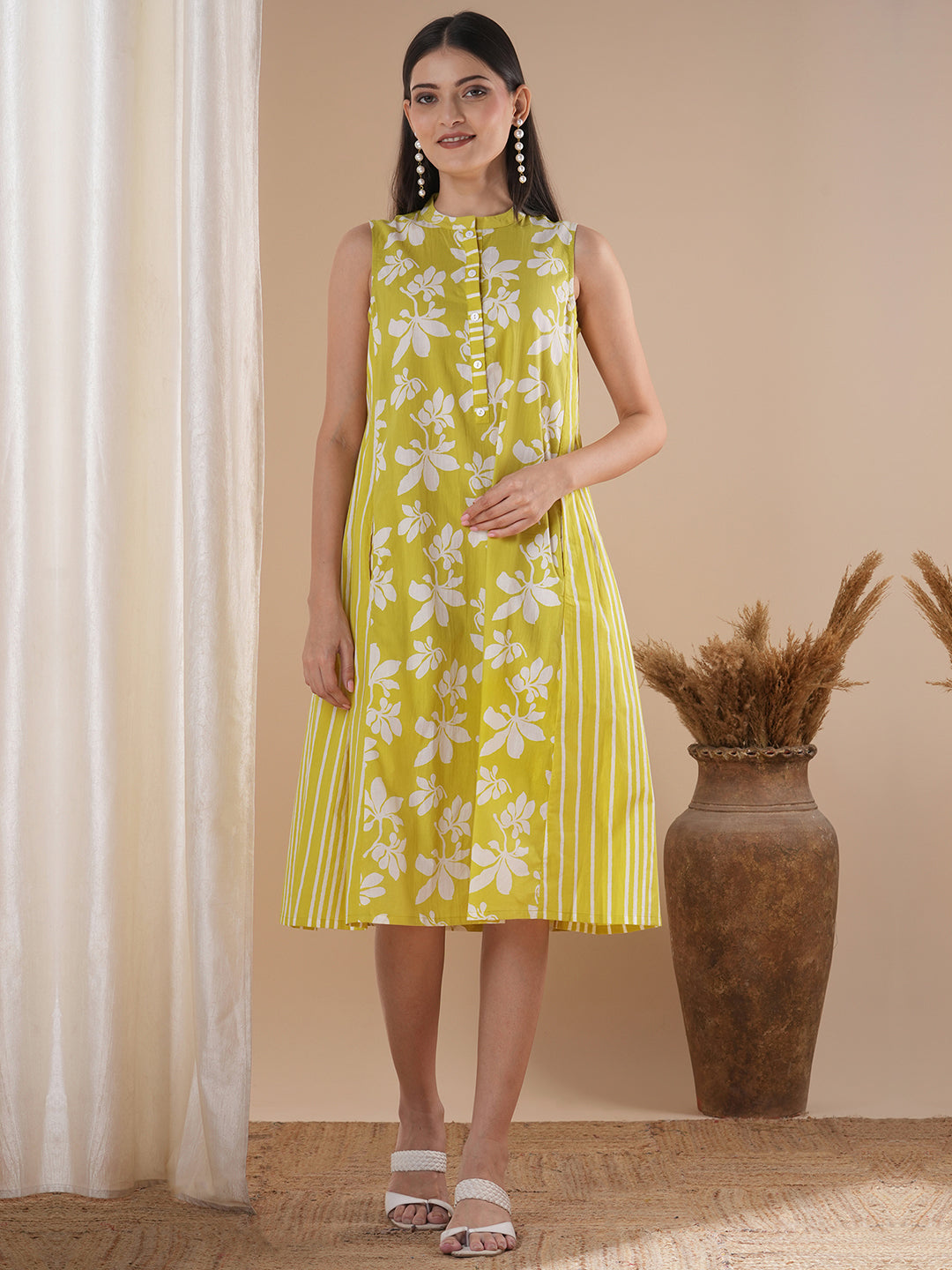 A printed dress with centre placket and pleated side panels with 2 pockets
