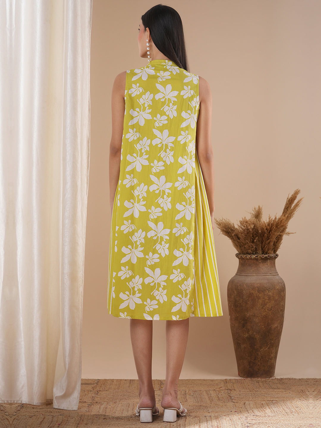 A printed dress with centre placket and pleated side panels with 2 pockets
