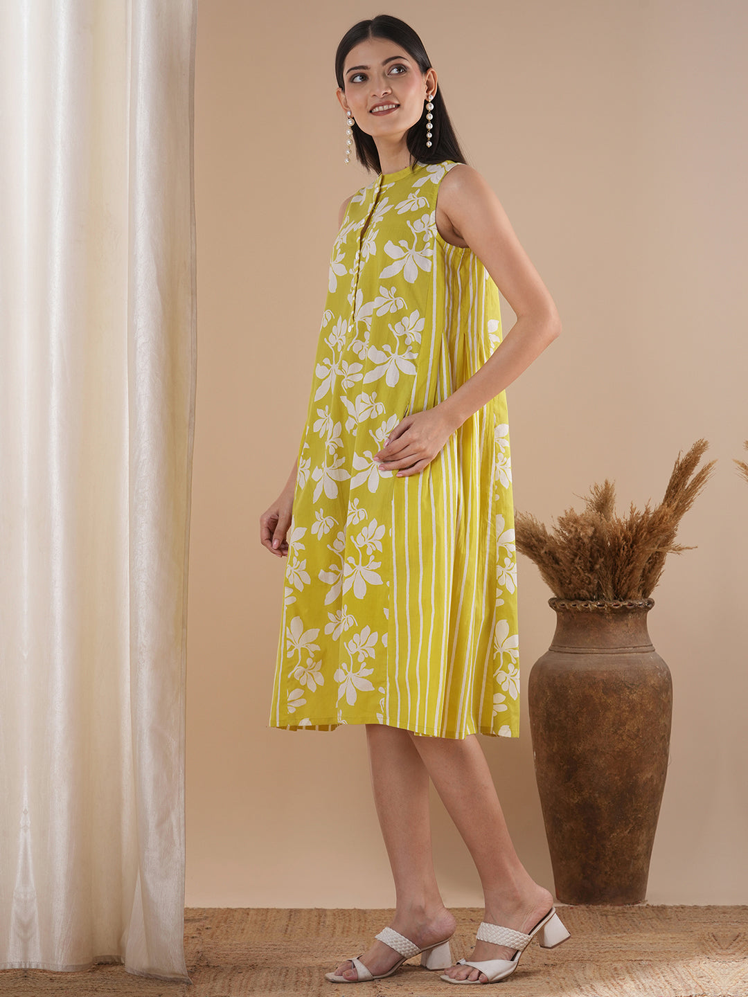 A printed dress with centre placket and pleated side panels with 2 pockets