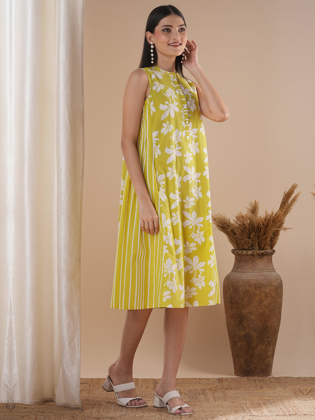 A printed dress with centre placket and pleated side panels with 2 pockets