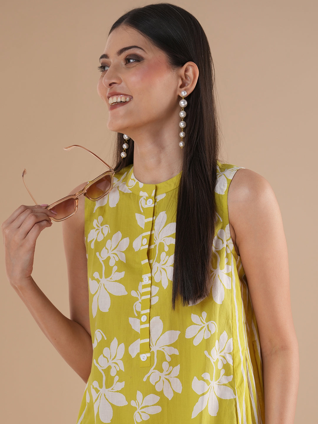 A printed dress with centre placket and pleated side panels with 2 pockets