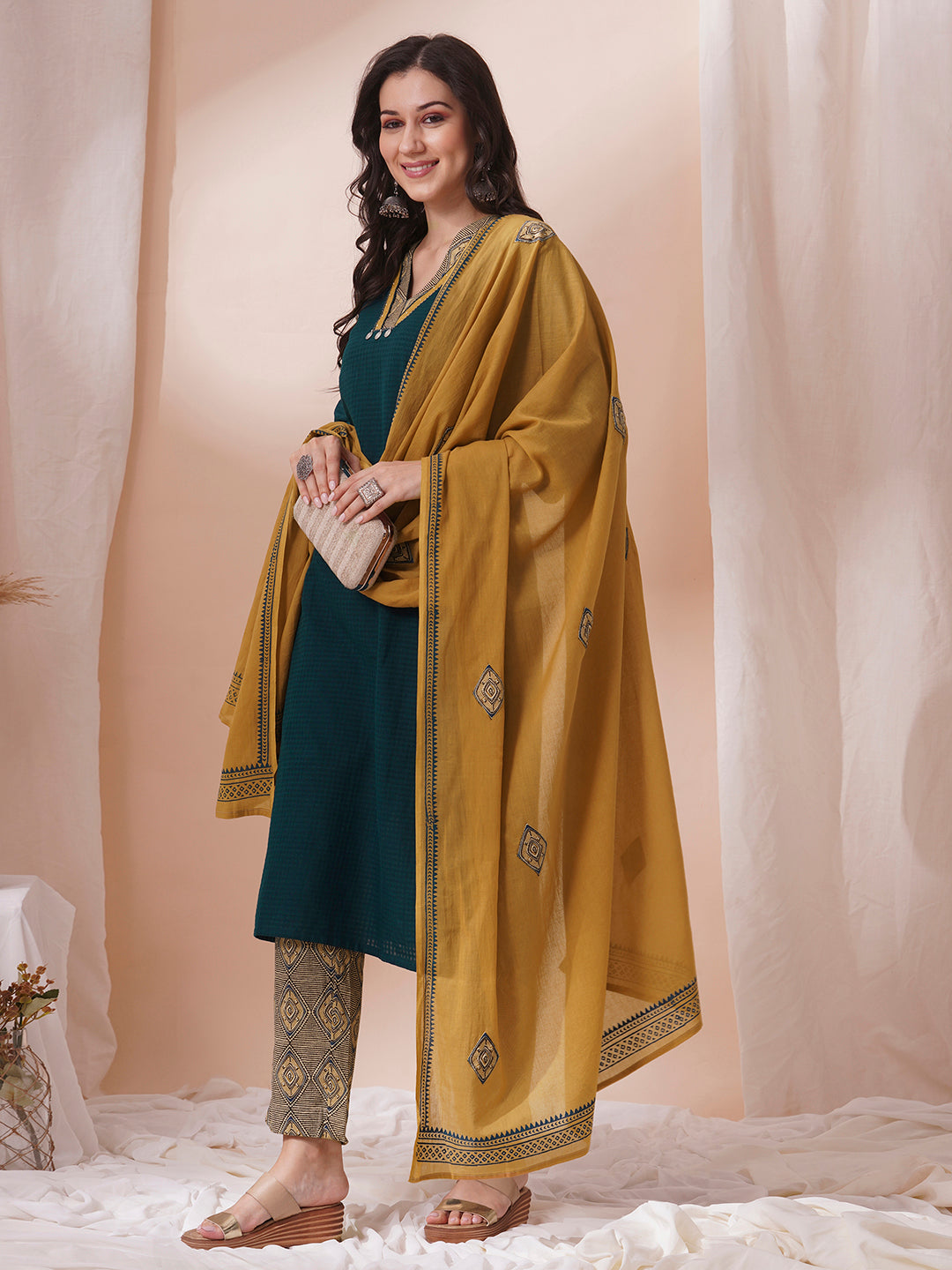 Forest green straight fit kurta suit set crafted with self dobby cotton fabric paired with geometric print bottom and applique dupatta.