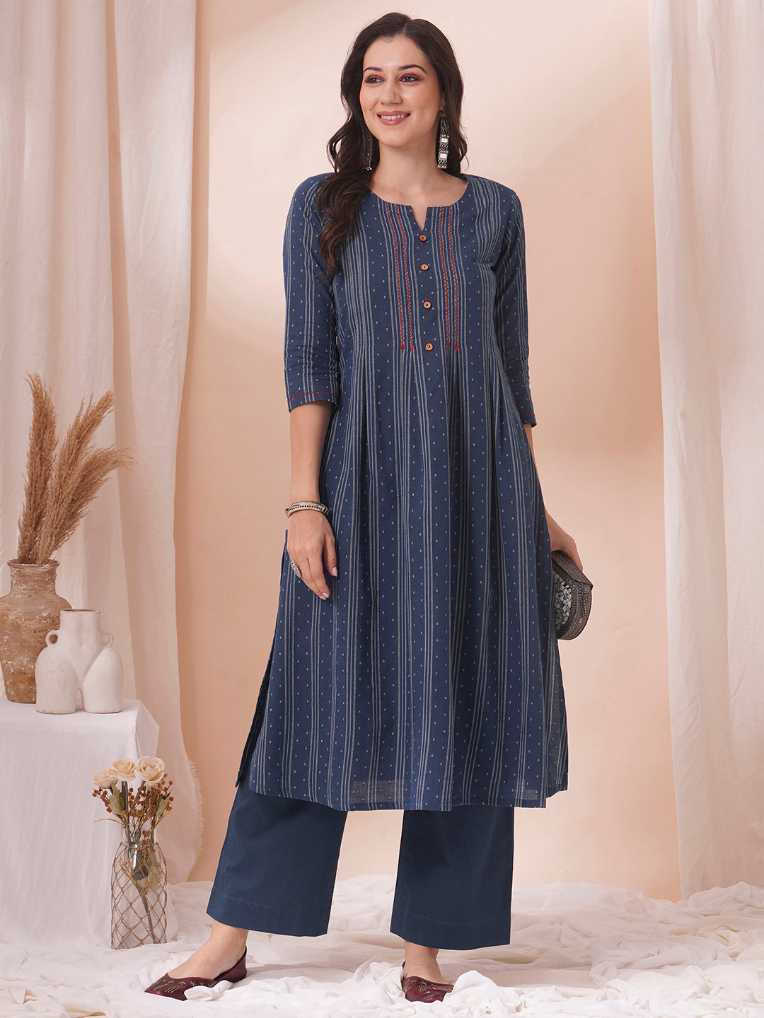 Box pleated dobby kurta in A-Line fit with hand embroidery and pocket.