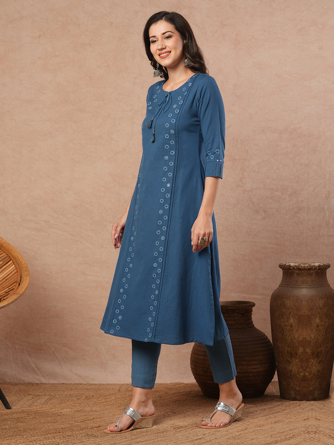 A-line cotton flex kurta with mirror work and attached thread tassels.