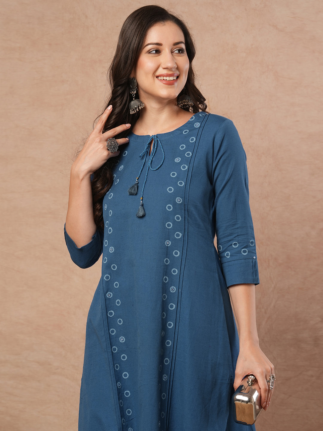 A-line cotton flex kurta with mirror work and attached thread tassels.