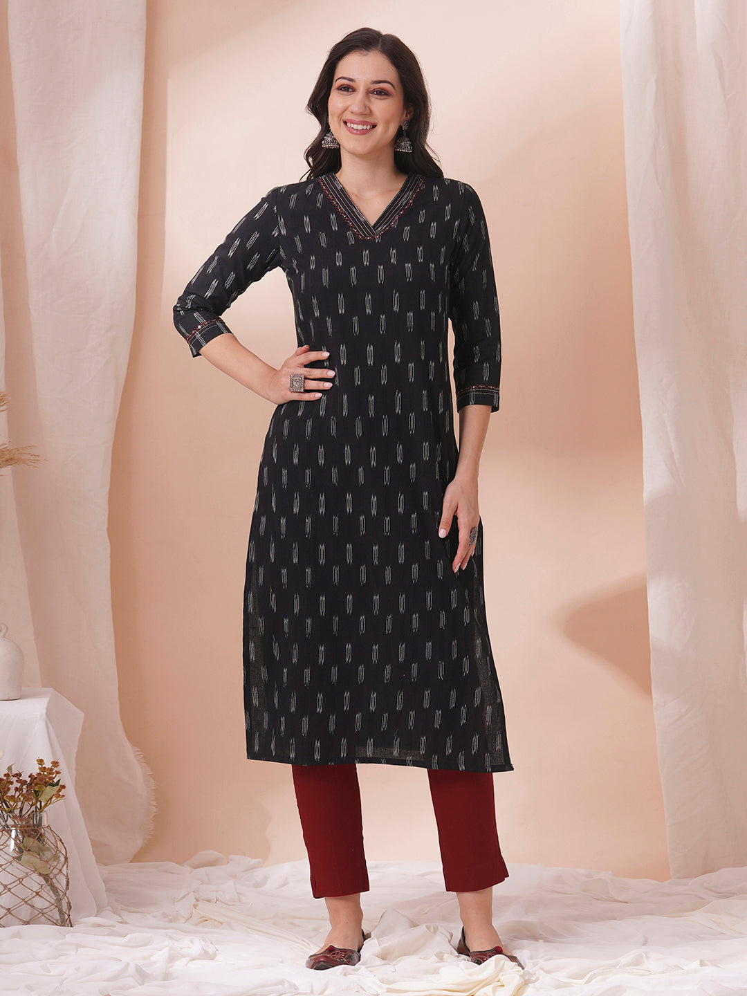 Straight fit cotton kurta in woven ikkat fabric with stitch lines and hand embroidery.