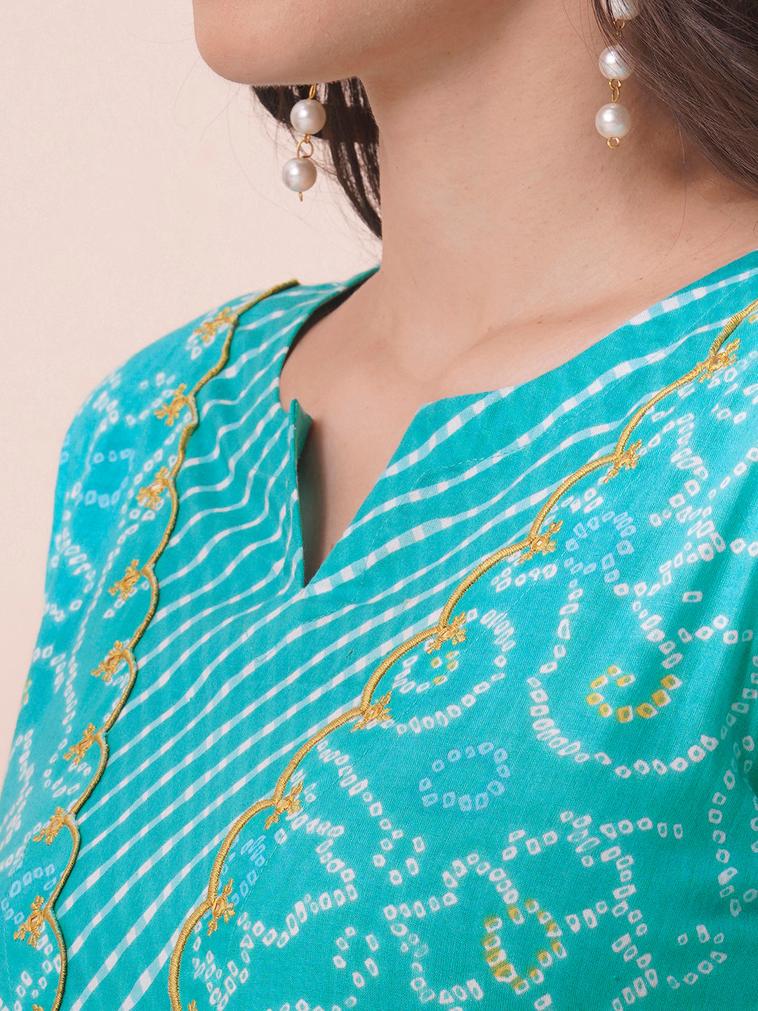 A-line bandhani print kurta with embroidery and cutwork detailing on the a zone and sleeve.