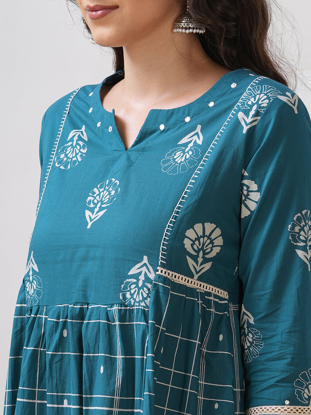 Pocketed A line kurta highlighted with lace, gathering and mirror work.