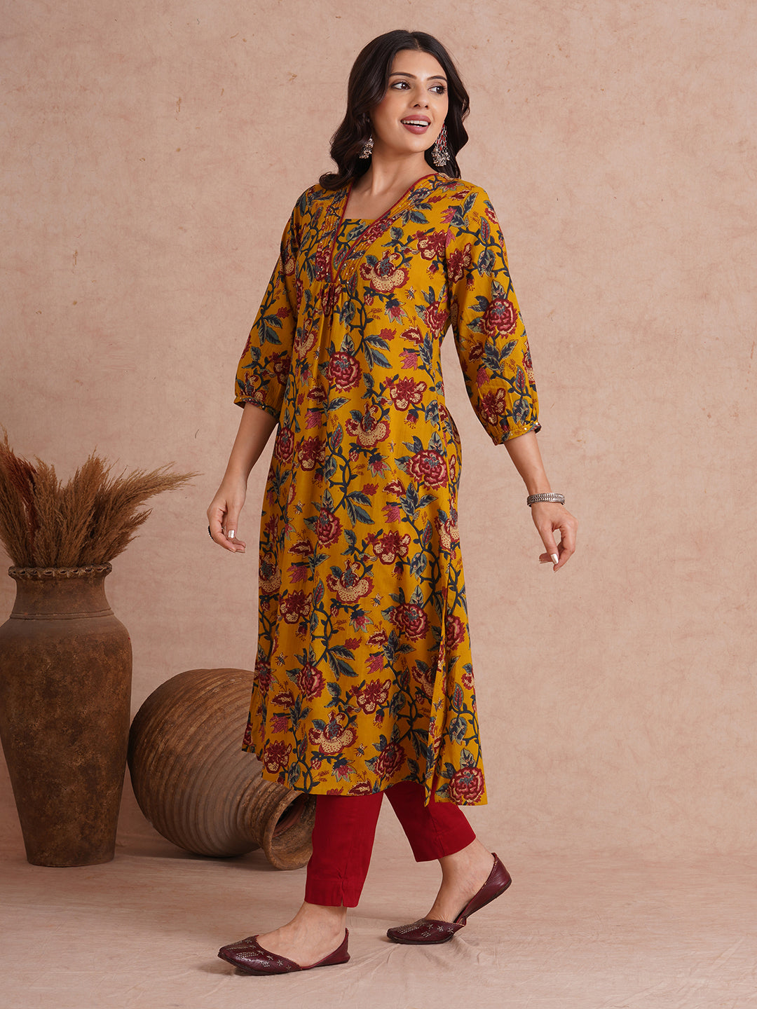 A-Line cotton print kurta with couching lines, sequin work, puffed sleeves and a pocket.