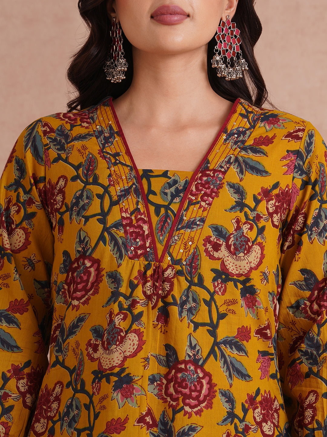 A-Line cotton print kurta with couching lines, sequin work, puffed sleeves and a pocket.