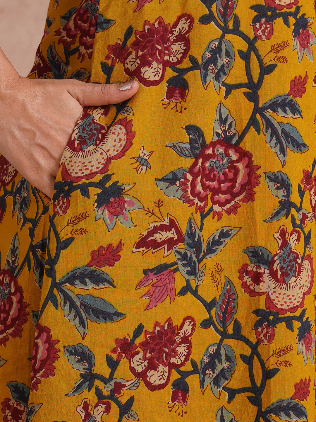 A-Line cotton print kurta with couching lines, sequin work, puffed sleeves and a pocket.