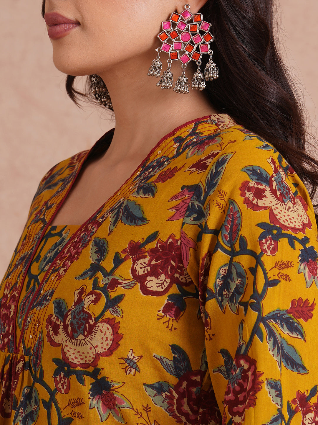 A-Line cotton print kurta with couching lines, sequin work, puffed sleeves and a pocket.