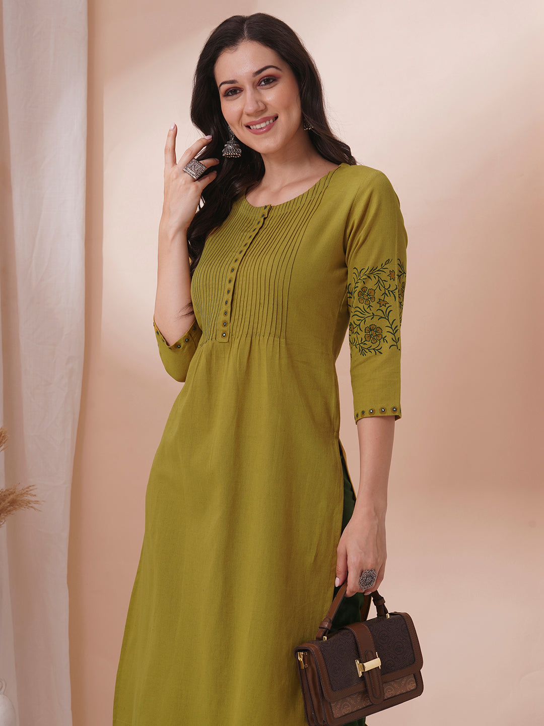 Straight fit kurta with pintucks and block printed sleeves and placket highlighted with mirrors.