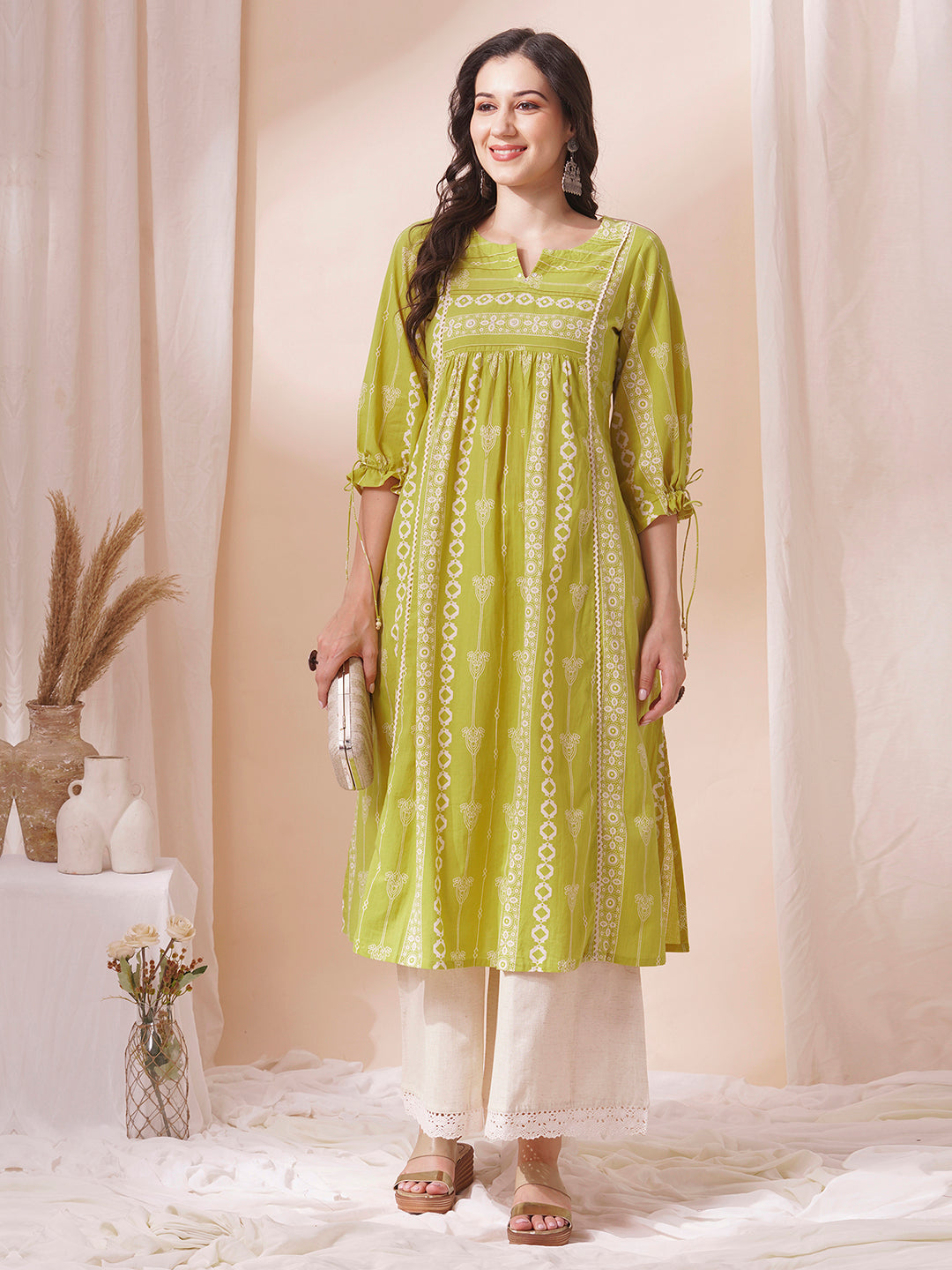 Shoulder princess A-line kurta with a horizontal stripe yoke with pintucks and mirrors.
