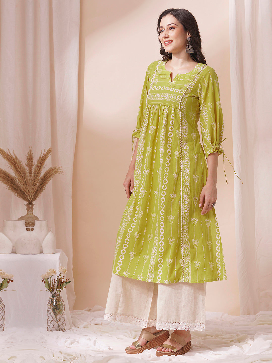 Shoulder princess A-line kurta with a horizontal stripe yoke with pintucks and mirrors.