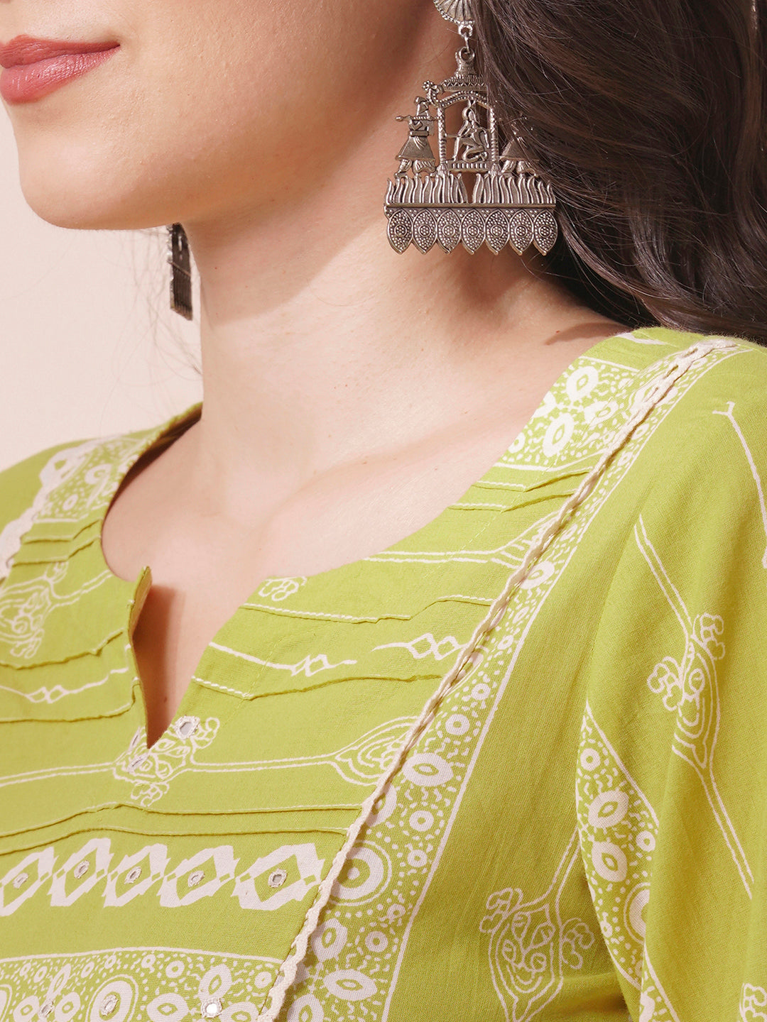 Shoulder princess A-line kurta with a horizontal stripe yoke with pintucks and mirrors.
