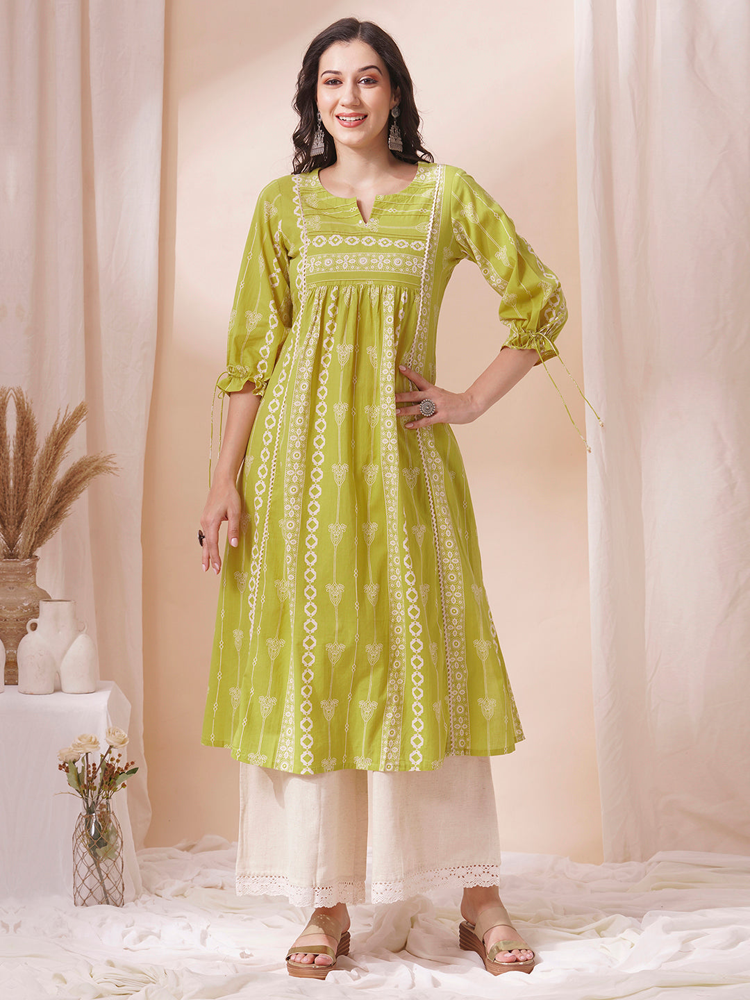 Shoulder princess A-line kurta with a horizontal stripe yoke with pintucks and mirrors.
