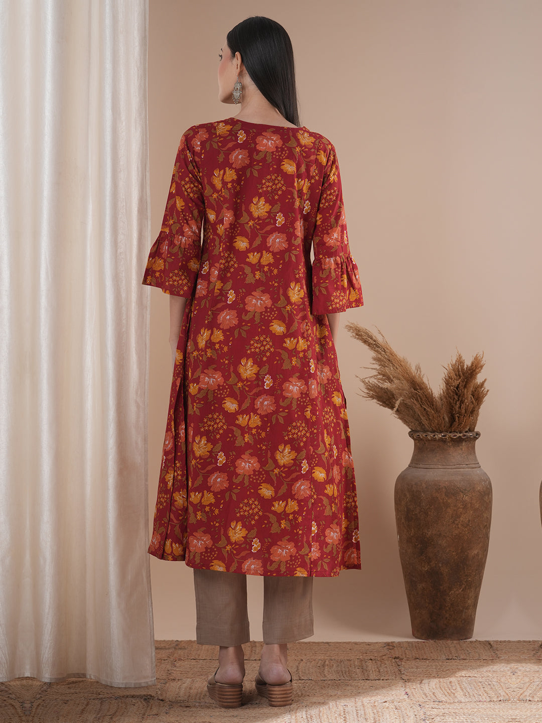 A printed shoulder princess A-line kurta with stitch lines on the shaped yoke and bell sleeves