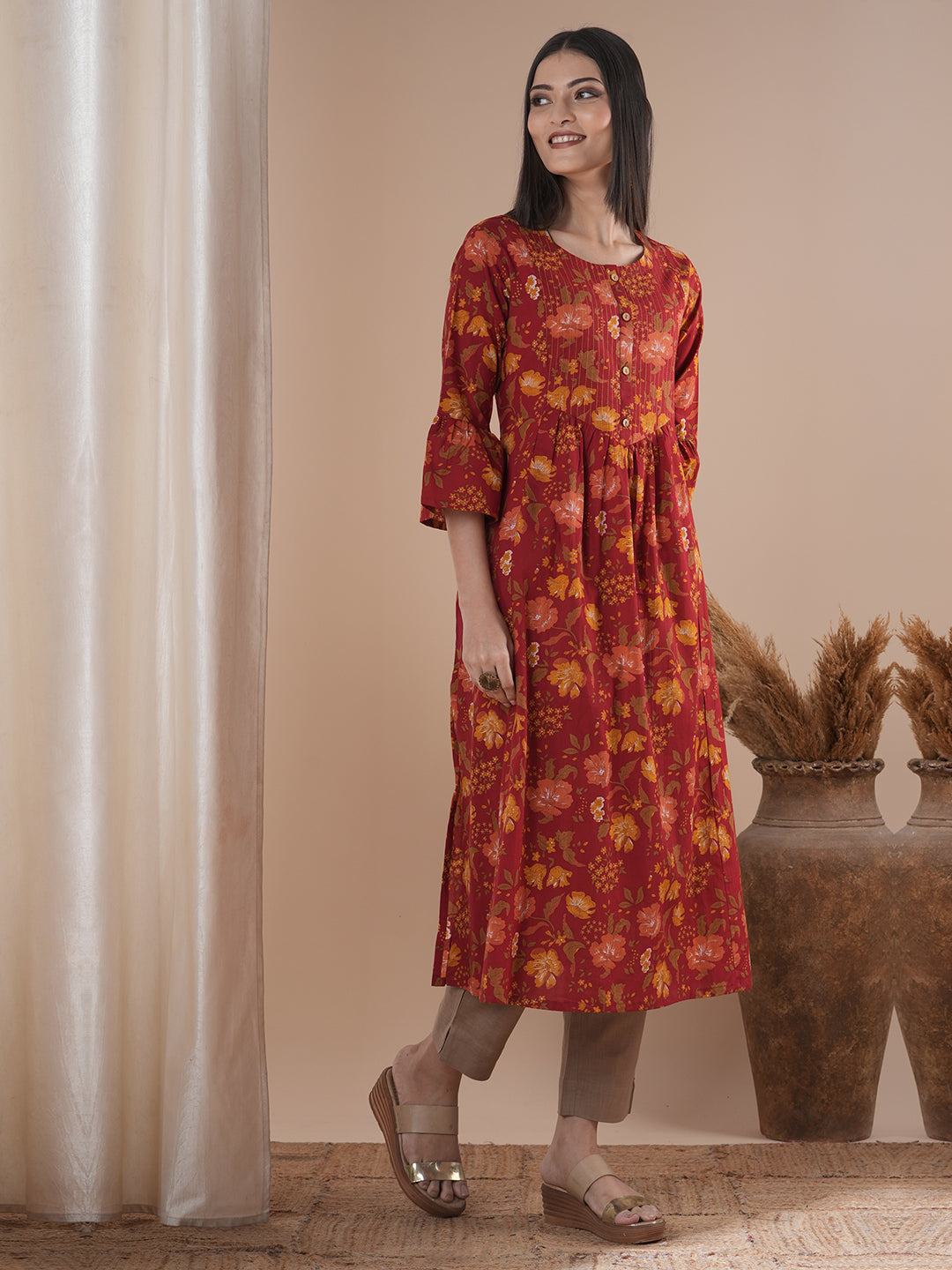 A printed shoulder princess A-line kurta with stitch lines on the shaped yoke and bell sleeves