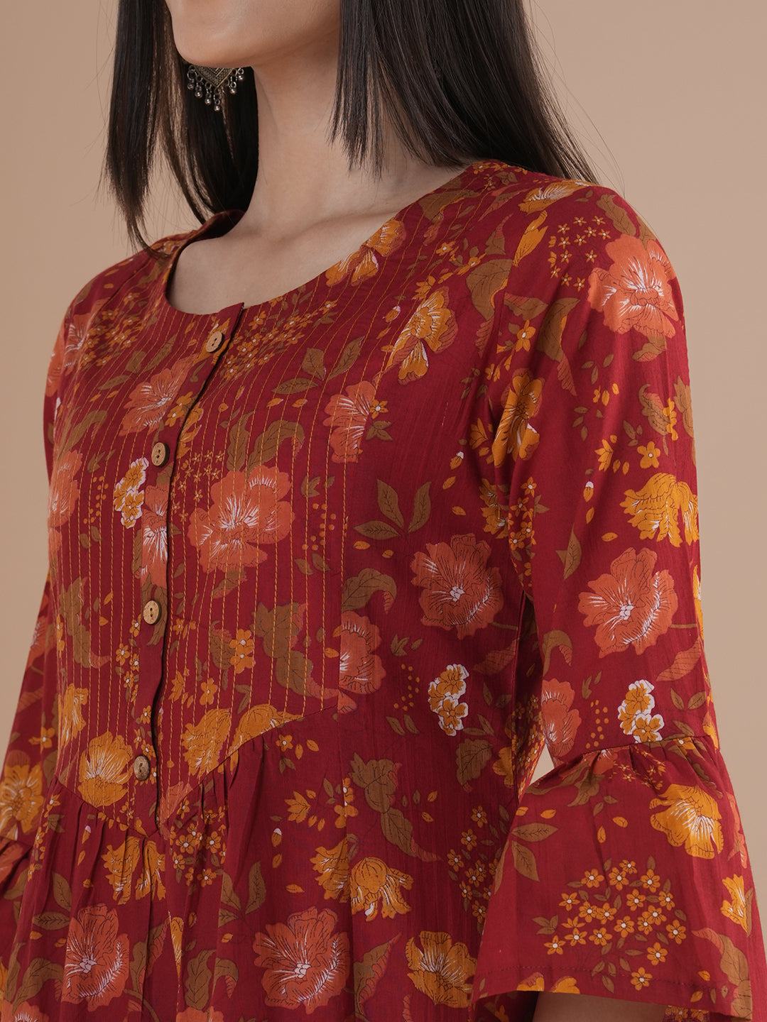 A printed shoulder princess A-line kurta with stitch lines on the shaped yoke and bell sleeves