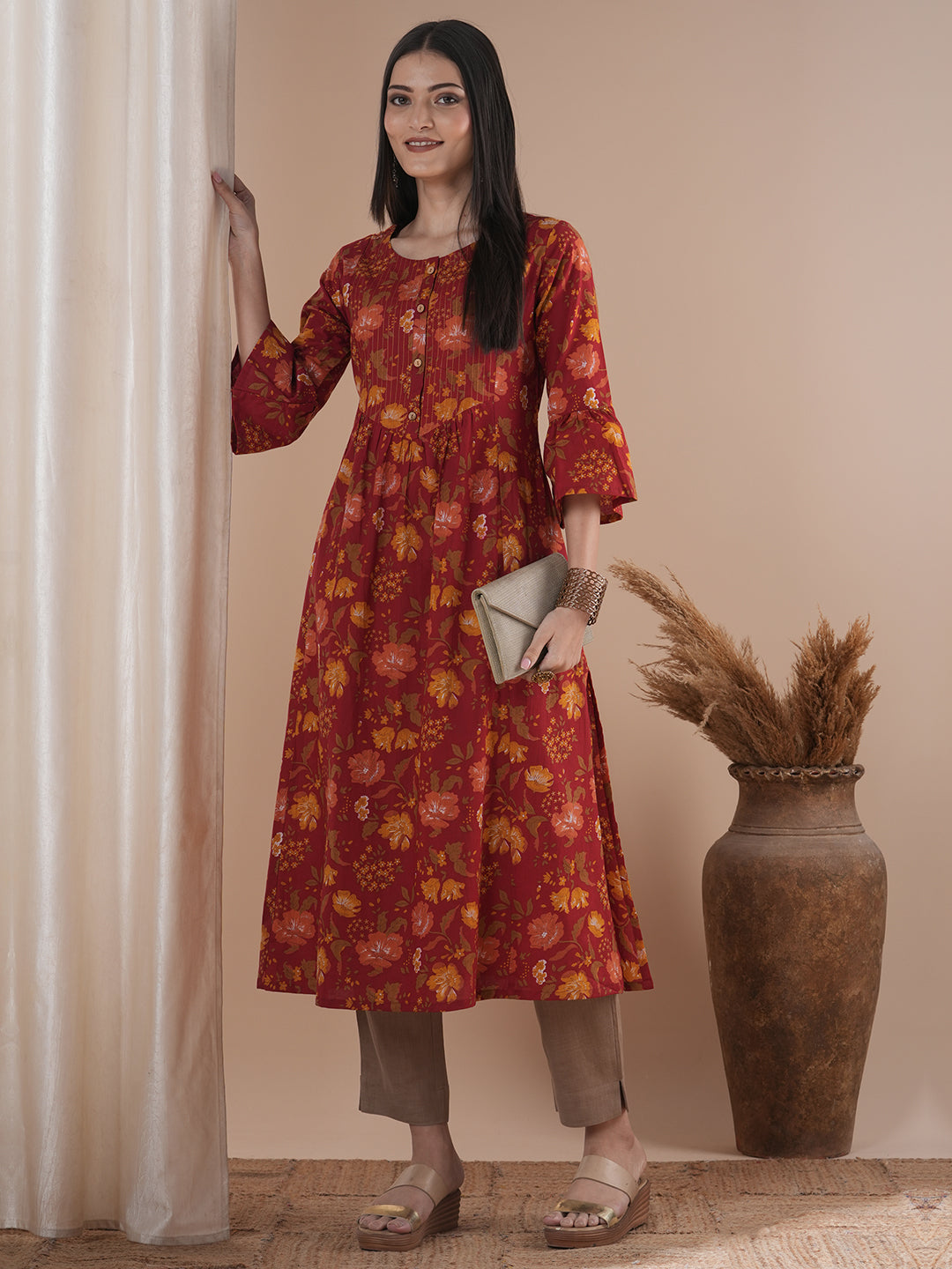 A printed shoulder princess A-line kurta with stitch lines on the shaped yoke and bell sleeves